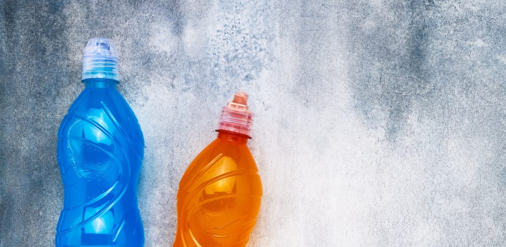 Blue and orange isotonic energy drink on a gray-blue background